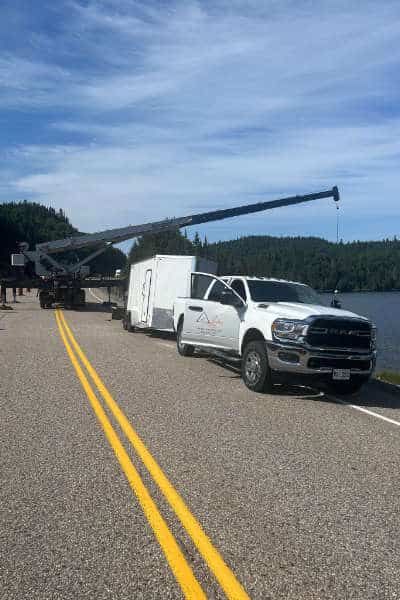 Pick-up truck and crane on side of an Northern Ontario highway
